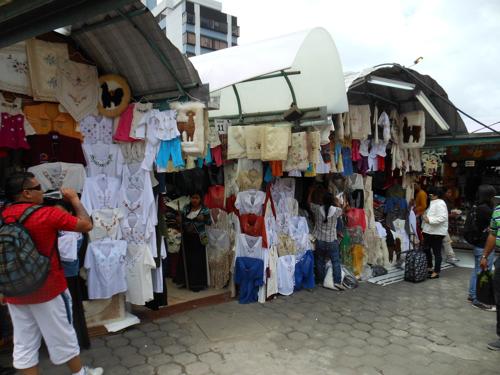 7 BEST ART AND CRAFTS MARKETS OF ECUADOR: Traditional Otavalo blouses, at art market, Quito, Ecuador