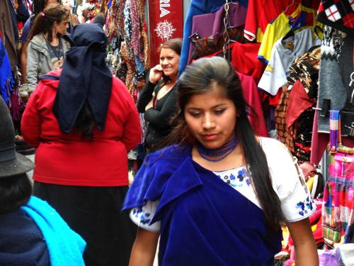 7 BEST ART, HANDICRAFTS MARKETS OF ECUADOR: Otavalo sales girl in traditional dress at Mariscal art market