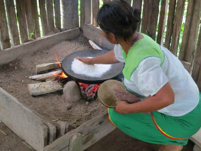 5 ECUADOR AMAZON TOURS [FROM QUITO]: Amazon Rainforest tribal Woman prepairing manioc for visitors of the Amazon in Ecuador.