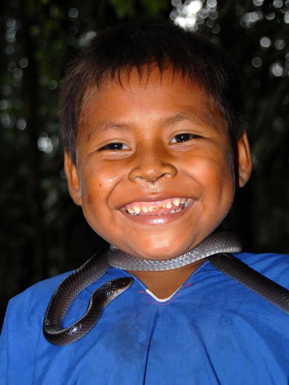 Cofan child playing with snake